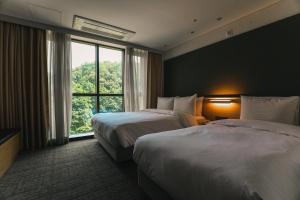 Postel nebo postele na pokoji v ubytování ON City Hotel