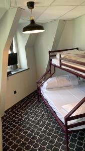 a bedroom with two bunk beds in a room at Safestay Brussels Grand Place in Brussels