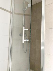 a shower with a glass door in a bathroom at Safestay Brussels Grand Place in Brussels