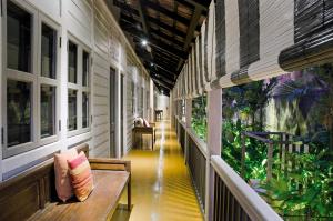 a hallway with a bench in a building with plants at Muntri Mews in George Town