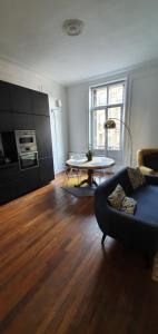 a living room with a couch and a table at L'Ecu : un Haussmannien accueillant! in Reims