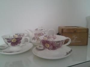 trois tasses à thé et soucoupes sur une table dans l'établissement Pen Llyn Bed and Breakfast, à Dinas