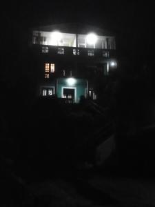 Cool Mount Guest في نوارا إليا: مبنى في الليل مع إضاءة عليه