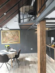 a kitchen and dining room with a table and chairs at Savoya nr2 Loft Studio Old City Center Self check-in Workspace in Timişoara