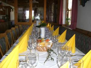a long table with wine glasses on it at Gasthaus St. Valentin in Chiusa