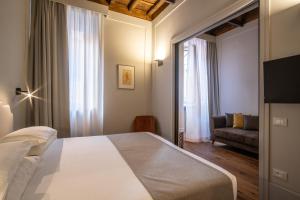 Postel nebo postele na pokoji v ubytování Hotel Smeraldo
