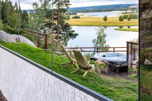a view from a balcony with a table and a bench at The WonderInn Mirrored Glass Cabin - Wonderinn Delta in Hektner +25 photos
