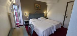 a bedroom with a large bed with white sheets at Metropol in Paris