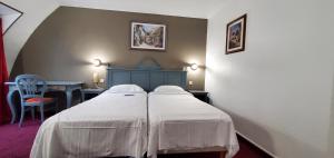 a hotel room with a bed with white sheets at Metropol in Paris
