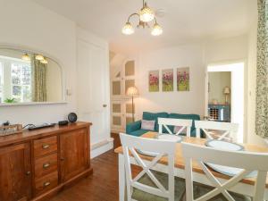 a living room with a table and chairs and a couch at Holmefield in Bakewell