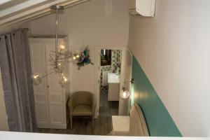 a living room with a chair and a mirror at Casa del Agua in Cazorla +83 photos
