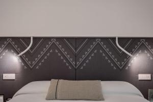 Postel nebo postele na pokoji v ubytování DOMU' MONTEGRAPPA 54