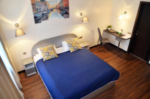 a bedroom with a blue bed and a desk at By Hermitage house in Saint Petersburg