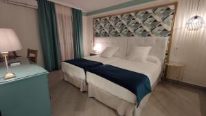 Posteľ alebo postele v izbe v ubytovaní Hotel Doña Blanca