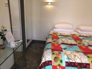 a hotel room with a bed and a mirror at Circles Guest House in Pewsey