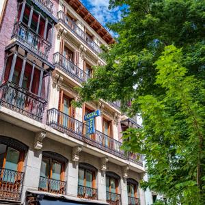 an apartment building with balconies on the side of it at Hostal Madrid in Madrid