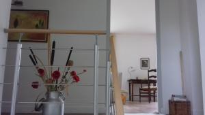 a vase with flowers in it in a room at chez sylvette in Quinsac +1 photo