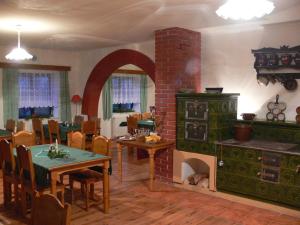 a living room with a fireplace and a table and a stove at Váňův statek in Pelhřimov