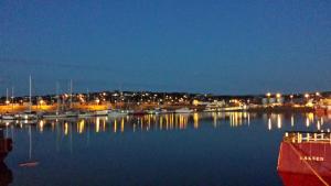 a marina at night with boats in the water at Bellavista Guest House in Kirkwall