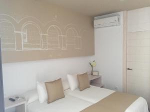 Postel nebo postele na pokoji v ubytování La Pasajera Hostal Boutique