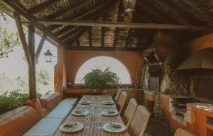 a long wooden table in a room with a window at Holiday Home Cloty in Vega de San Mateo