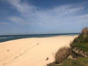 a beach with people on it and the ocean at 2 Lapwing Drive in Hayle