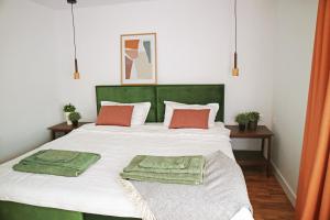 a bedroom with a large white bed with red pillows at Modern Cozy Apartment - NEW in Kyustendil