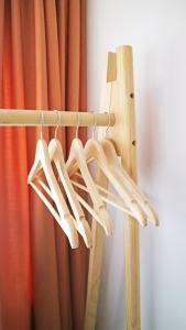 a bunch of wooden hangers in front of a curtain at Modern Cozy Apartment - NEW in Kyustendil