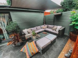 a patio with a couch and a table at Cosy Studio in Newmarket