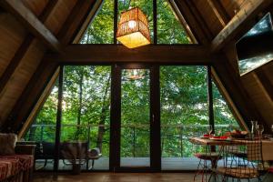 a large glass window in a room with a table and chairs at Hai La Munte Bran in Bran