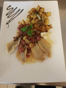 a plate of food on a white plate at Alemannenhof Hotel Engel in Rickenbach