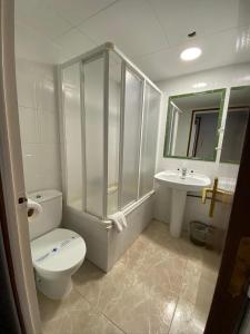 a bathroom with a toilet and a sink at Apartamentos Mitus in Canet de Mar