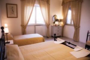 Postel nebo postele na pokoji v ubytování Bed and Breakfast Nonna Loreta