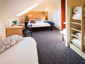 a hotel room with two beds and a desk at greet Hotel Beaune in Beaune