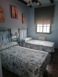 A bed or beds in a room at Casa Arroyomolinos-Planta Superior
