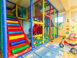 a childs play room with a slide and play equipment at 3L Apartments Diva in Kołobrzeg