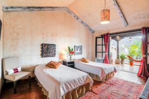 מיטה או מיטות בחדר ב-Casa Serenidad