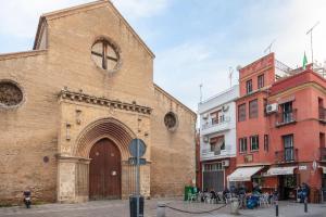 a large brick building with a large door on a street at Bordador in Seville