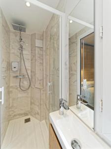 a bathroom with a shower and a sink at Kyriad DIRECT Saint Brieuc - Parc des Expositions in Tregueux