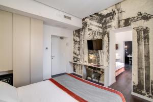 a bedroom with a bed and a wall with a mural at Albergo Abruzzi in Rome