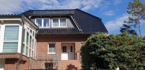 a house with solar panels on the roof at Ferienwohnung - Hitzacker - Tiessau de in Hitzacker