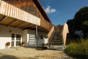 a house with a wooden stairway leading up to a building at Naturlaub.pur in Waldmünchen