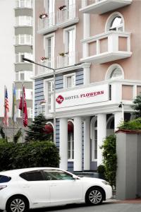 a white car parked in front of a hotel honors at Flowers Hotel in Chişinău