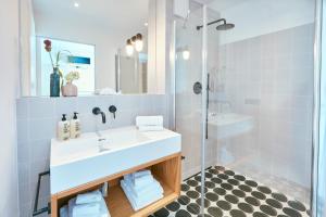 a bathroom with a white sink and a shower at Lieblingsplatz Strandhotel in Sankt Peter-Ording +72 photos