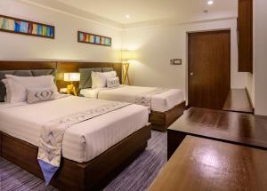 Tempat tidur dalam kamar di Hotel Zakaria International