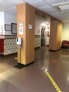 a hallway with two wooden columns in a building at Hotel Cant&oacute;n in Barcelona