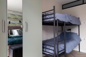 a room with two bunk beds in it at B&B Doremi in Kaatsheuvel