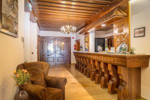 a bar with a row of chairs in a room at Hotel Böhmerwaldhof in Ulrichsberg