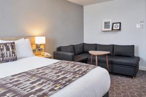 um quarto de hotel com uma cama e um sofá em Holiday Inn Ellesmere Port/Cheshire Oaks, an IHG Hotel em Ellesmere Port