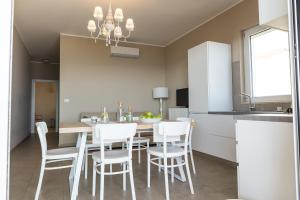 een keuken en eetkamer met een tafel en stoelen bij Cavalluccio Marino in Mazzeo